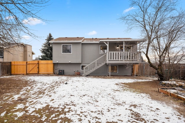 snow covered property featuring cooling unit and covered porch