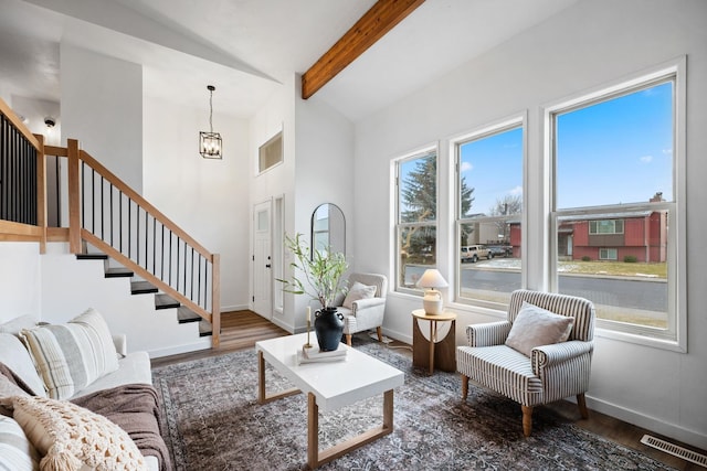 living room featuring dark hardwood / wood-style floors, vaulted ceiling with beams, and a chandelier