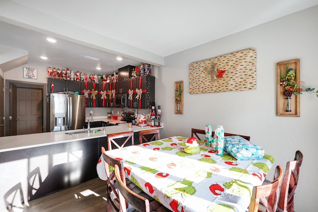 dining space with dark hardwood / wood-style flooring and sink