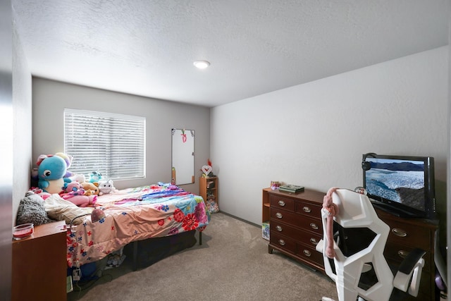 carpeted bedroom featuring a textured ceiling