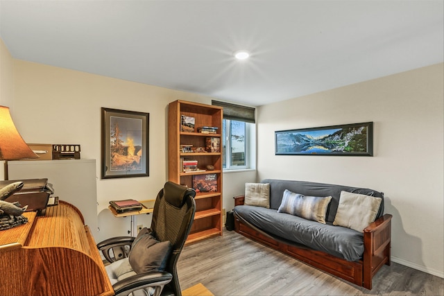 home office with light hardwood / wood-style flooring