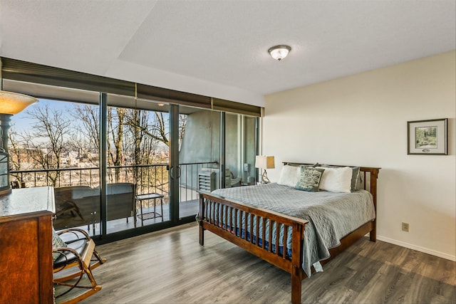 bedroom with wood-type flooring and access to outside