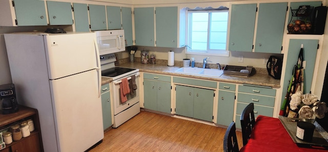 kitchen with sink, white appliances, and light wood-type flooring