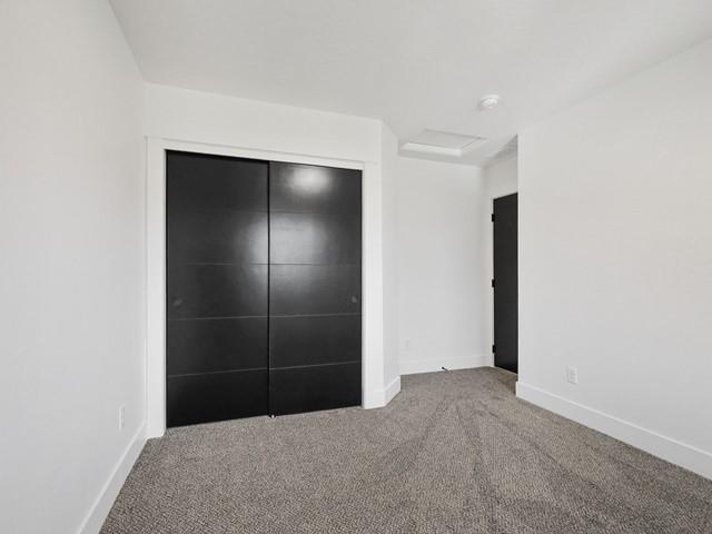 unfurnished bedroom with carpet floors and a closet