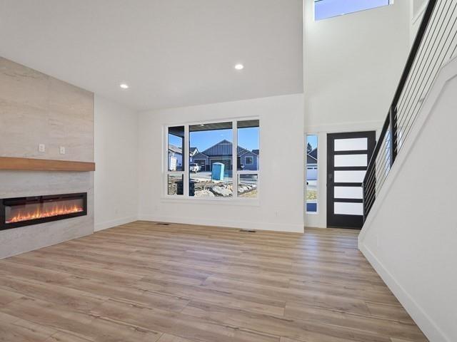 unfurnished living room featuring a fireplace and light wood-type flooring