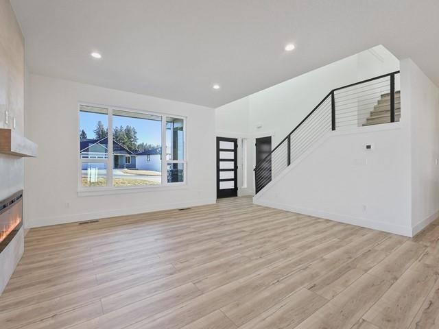 unfurnished living room featuring light wood-type flooring