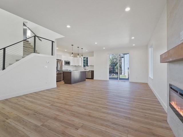 unfurnished living room with light hardwood / wood-style flooring