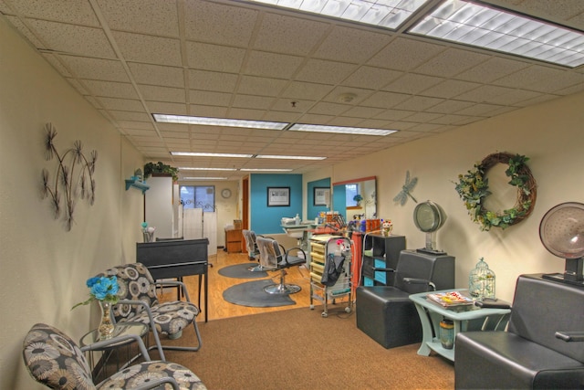 carpeted office featuring a paneled ceiling