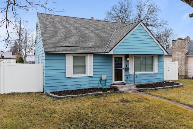 bungalow-style house featuring a front yard