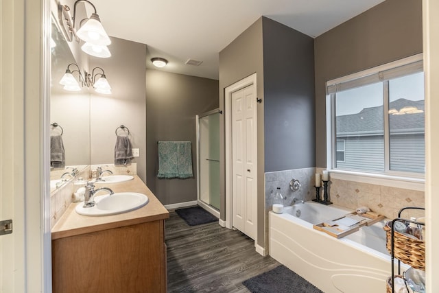 bathroom with vanity, hardwood / wood-style flooring, and independent shower and bath