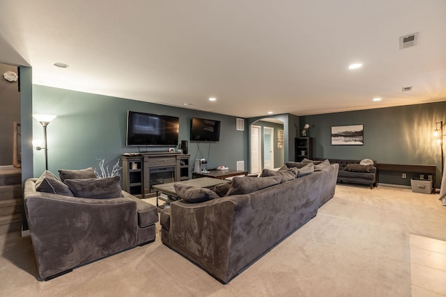 living room featuring light carpet and a fireplace