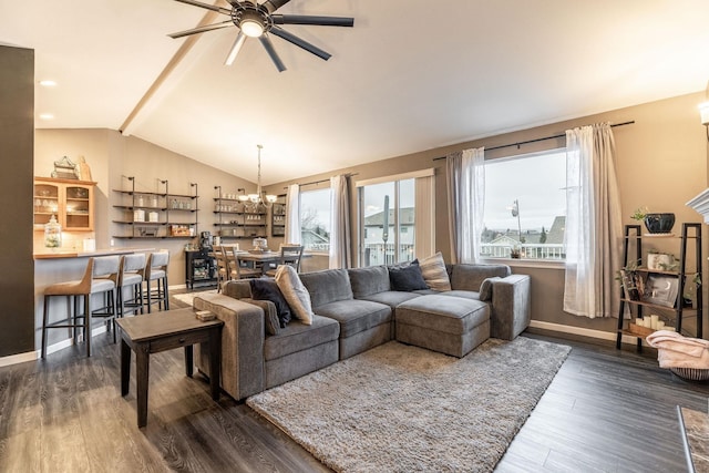 living room featuring ceiling fan with notable chandelier, dark hardwood / wood-style flooring, and vaulted ceiling