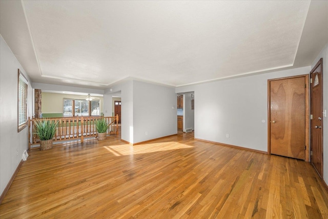 empty room featuring ceiling fan and light wood-type flooring