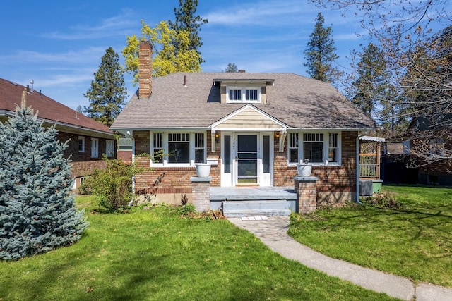 3224 W Cora Ave, Spokane, WA 99205 - view of front of property featuring brick siding, a front lawn, and a chimney