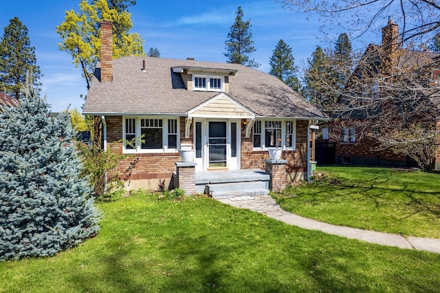 3224 W Cora Ave, Spokane, WA 99205 - view of front of home featuring brick siding, roof with shingles, a chimney, and a front yard