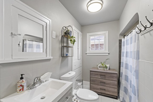 3224 W Cora Ave, Spokane, WA 99205 - full bathroom featuring tile walls, vanity, toilet, marble finish floor, and a shower with shower curtain