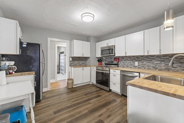 3224 W Cora Ave, Spokane, WA 99205 - kitchen featuring a sink, white cabinets, stainless steel appliances, and a textured ceiling