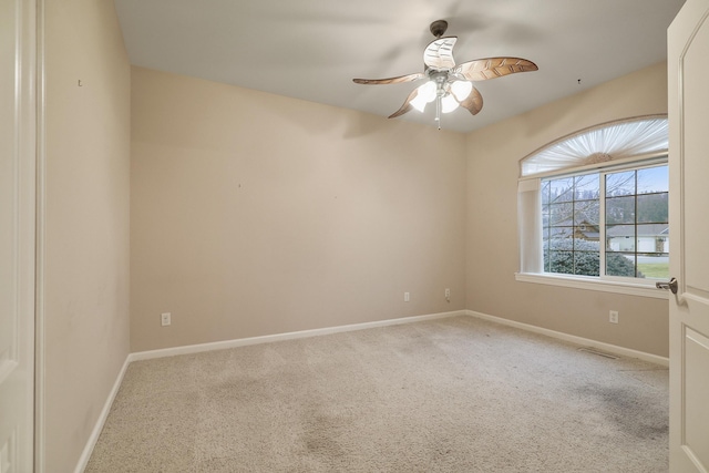 carpeted empty room featuring ceiling fan