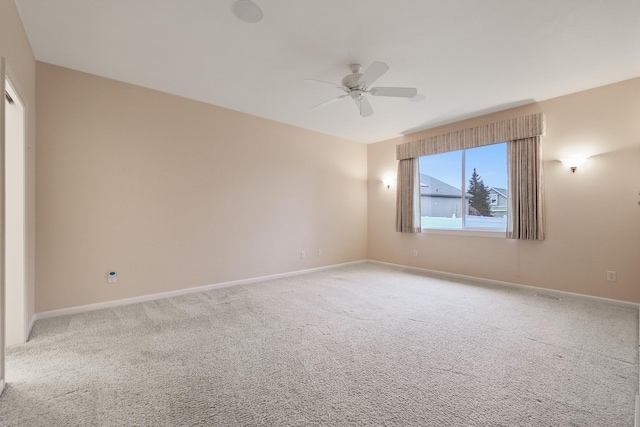 unfurnished room with ceiling fan and carpet flooring