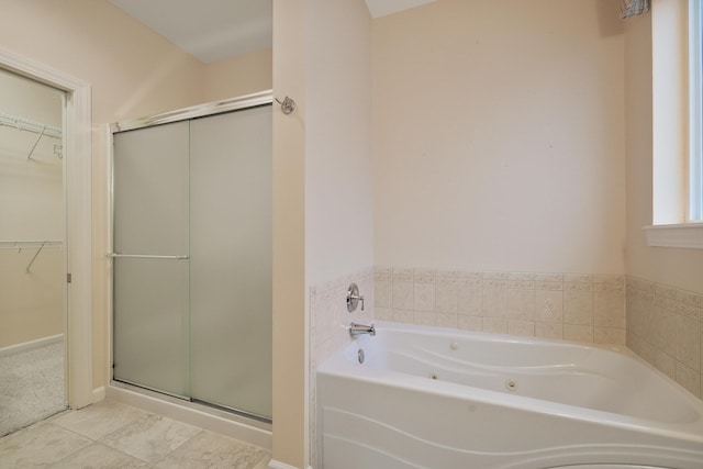 bathroom featuring separate shower and tub and tile patterned flooring