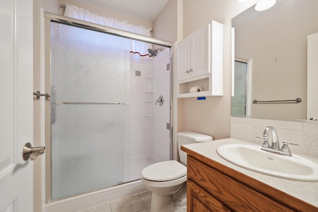 bathroom with walk in shower, tile patterned floors, toilet, vanity, and decorative backsplash