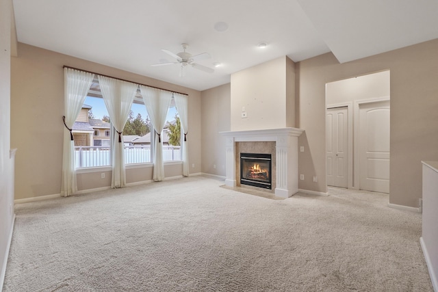 unfurnished living room featuring light colored carpet and ceiling fan