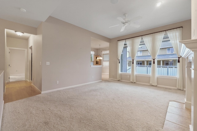 spare room featuring light colored carpet and ceiling fan