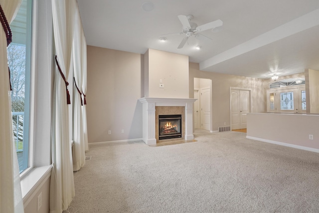 unfurnished living room with light colored carpet and ceiling fan