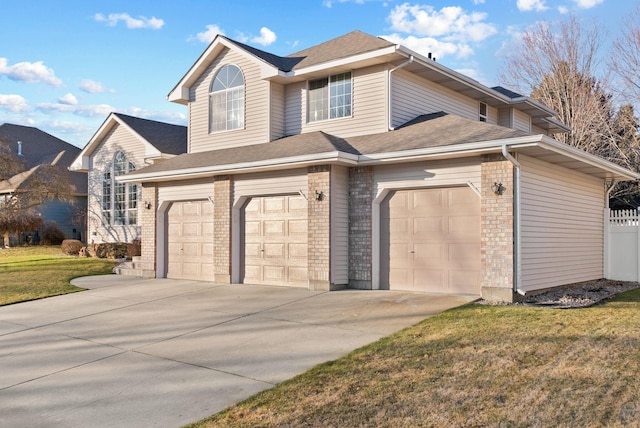 view of front of property featuring a garage and a front yard