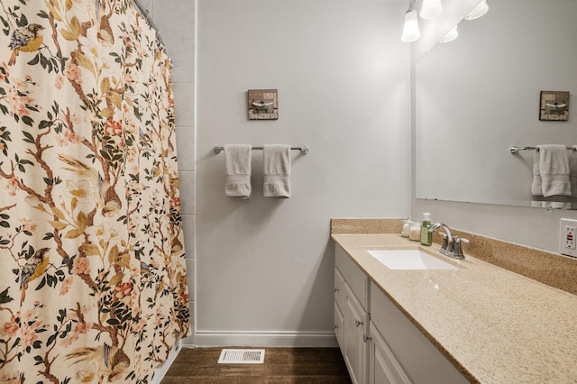 bathroom featuring vanity and wood-type flooring