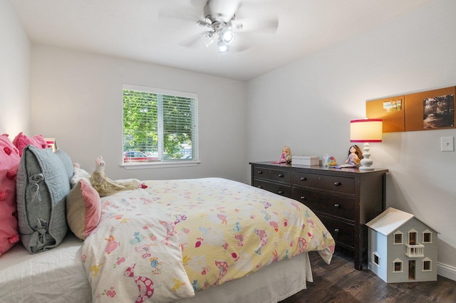 bedroom with dark hardwood / wood-style flooring and ceiling fan