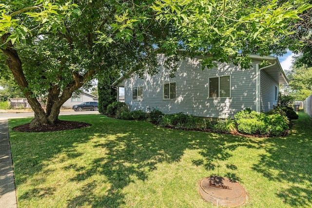 view of side of home featuring a lawn