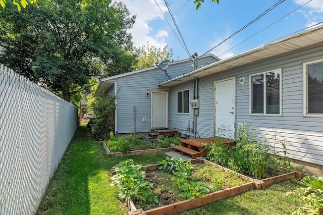 rear view of property with a lawn