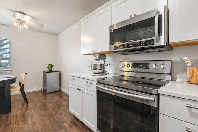 kitchen featuring white cabinetry, ceiling fan, stainless steel appliances, and dark hardwood / wood-style floors