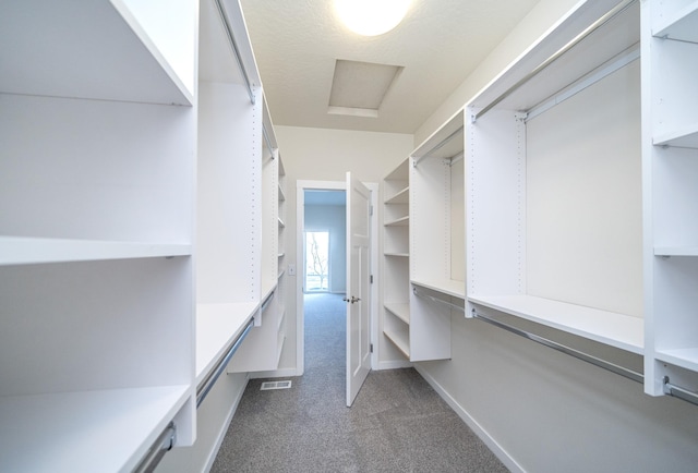 spacious closet featuring dark carpet