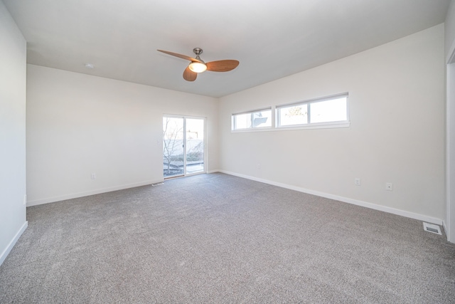 carpeted spare room featuring ceiling fan