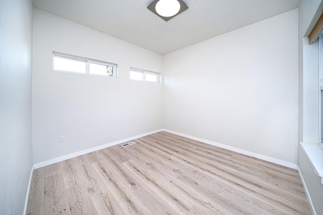 unfurnished room featuring light hardwood / wood-style floors