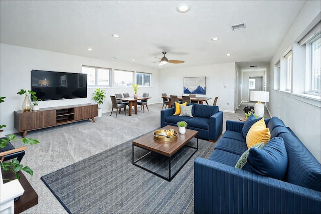 living room with carpet, plenty of natural light, and ceiling fan