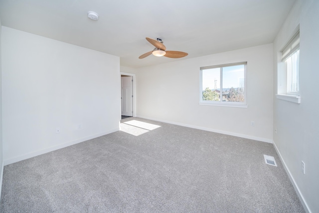 spare room featuring carpet floors and ceiling fan