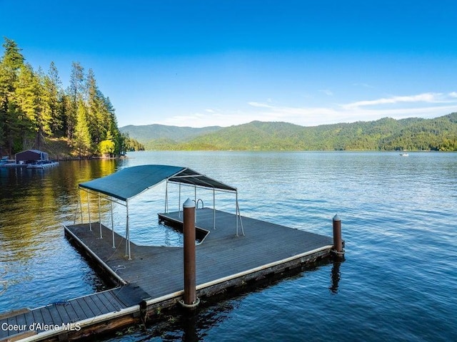 view of dock featuring a water and mountain view