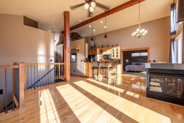 interior space with beam ceiling, a chandelier, high vaulted ceiling, and light wood-type flooring