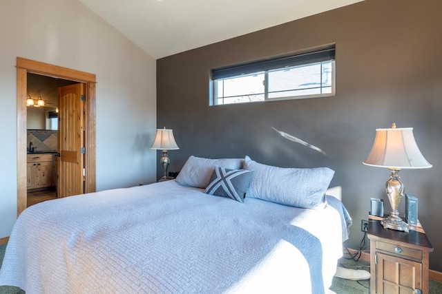 bedroom with vaulted ceiling and ensuite bath