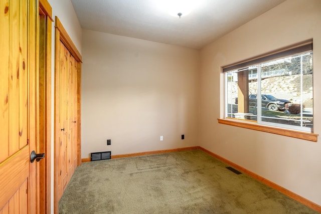 unfurnished bedroom with carpet floors and a closet