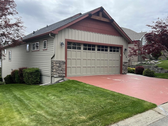 8518 E Sandlewood Ln, Spokane, WA 99217 - view of home's exterior featuring stone siding, a yard, roof with shingles, and a garage