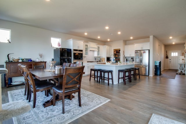 dining room with a healthy amount of sunlight and light hardwood / wood-style flooring