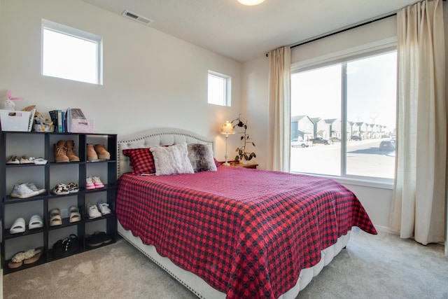 bedroom featuring light colored carpet