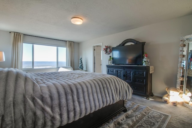 carpeted bedroom featuring a textured ceiling