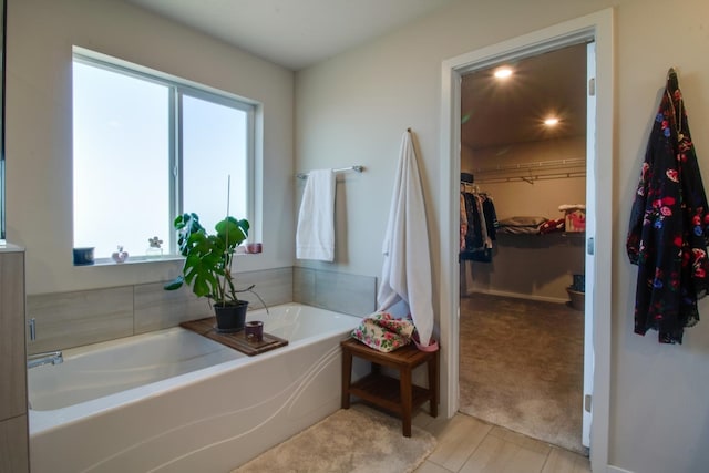 bathroom featuring a healthy amount of sunlight, a bath, and hardwood / wood-style floors