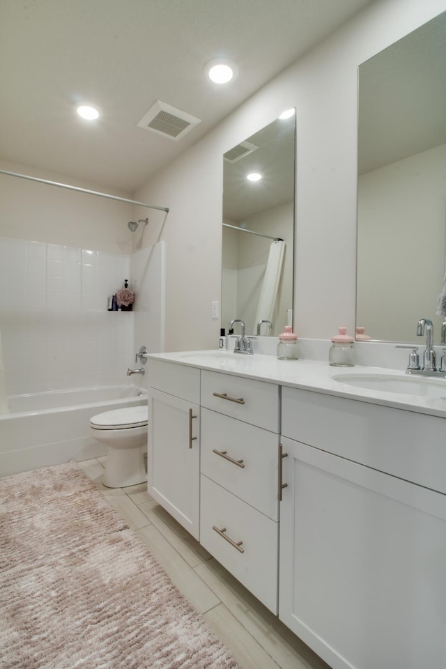 full bathroom with vanity, shower / bathtub combination, and toilet