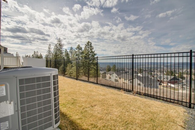 exterior space featuring cooling unit and a yard